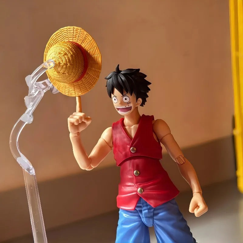 Action figure of a character from a popular anime series holding a straw hat. One Piece: Monkey D. Luffy (Romance Dawn Ver.) Authentic S.H. Figuarts Fully Articulated Action Figure by Bandai Spirits