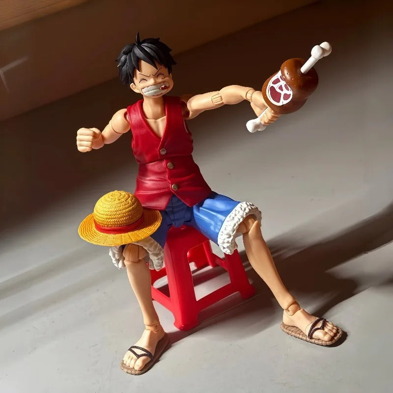 Action figure of a character from a popular anime series on a gray surface. One Piece: Monkey D. Luffy (Romance Dawn Ver.) Authentic S.H. Figuarts Fully Articulated Action Figure by Bandai Spirits