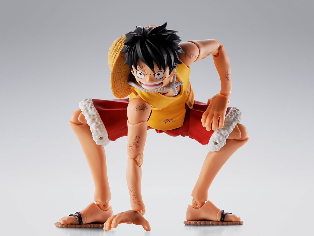 Action figure of a character in a dynamic pose on a gray background One Piece: Monkey D. Luffy (Summit War of Marineford Ver.) Authentic S.H. Figuarts Fully Articulated Action Figure by Bandai Spirits