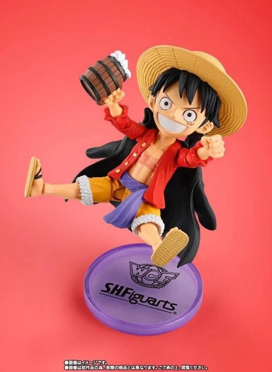 Action figure of a character from a popular anime series on a red background One Piece: Monkey D. Luffy (WCF x S.H. Figuarts Ver.) Authentic Fully Articulated Chibi Action Figure by Bandai Spirits