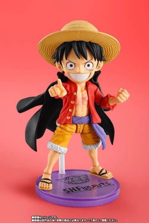 Figurine of a character from an anime on a red background One Piece: Monkey D. Luffy (WCF x S.H. Figuarts Ver.) Authentic Fully Articulated Chibi Action Figure by Bandai Spirits
