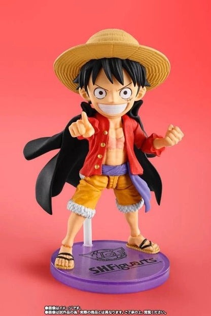 Figurine of a character from an anime on a red background One Piece: Monkey D. Luffy (WCF x S.H. Figuarts Ver.) Authentic Fully Articulated Chibi Action Figure by Bandai Spirits