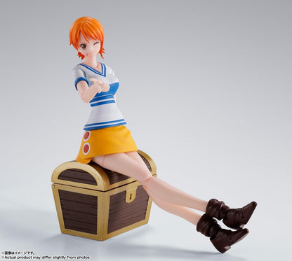 Figurine of a character with orange hair and a yellow skirt sitting on a treasure chest. One Piece: Nami (Romance Dawn Ver.) Authentic S.H. Figuarts Fully Articulated Action Figure by Bandai Spirits