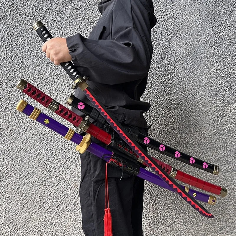 Person holding multiple katana swords against a plain background One Piece: Roronoa Zoro 41-Inch Authentic Replica Bamboo Katana