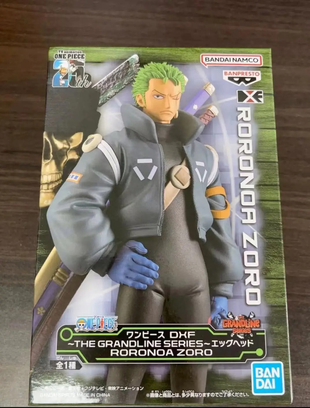 Action figure packaging of Roronoa Zoro from One Piece on a wooden surface One Piece: Roronoa Zoro (Future Island Egghead Ver.) Authentic 17cm PVC Showcase Scale Statue by Banpresto