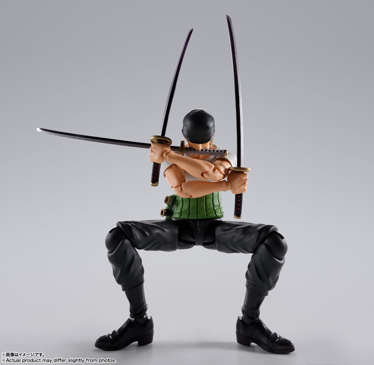 Action figure with two swords on a gray background One Piece: Roronoa Zoro (Romance Dawn Ver.) Authentic S.H. Figuarts Fully Articulated Action Figure by Bandai Spirits