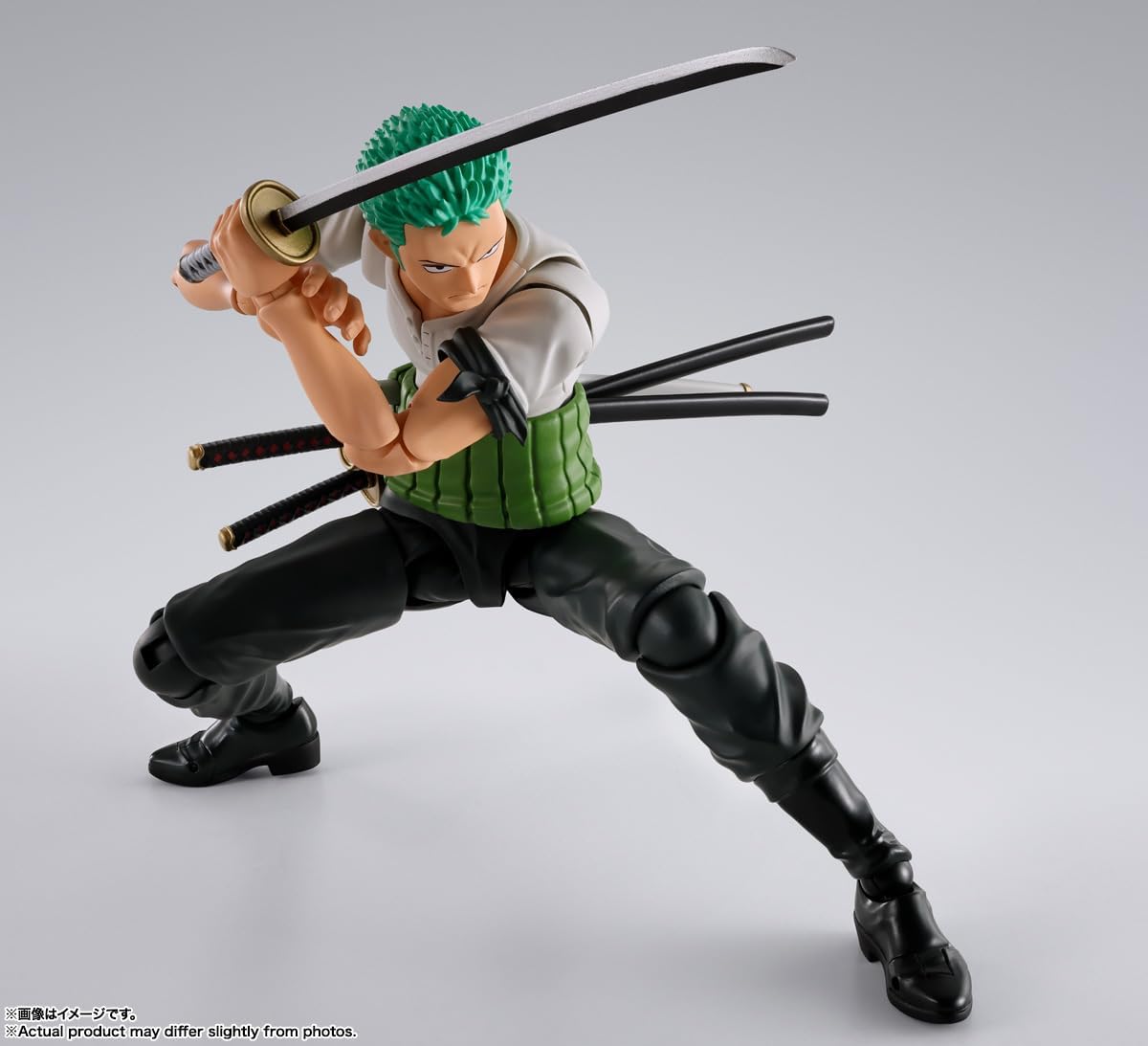 Action figure of a character with green hair and multiple swords on a gray background One Piece: Roronoa Zoro (Romance Dawn Ver.) Authentic S.H. Figuarts Fully Articulated Action Figure by Bandai Spirits