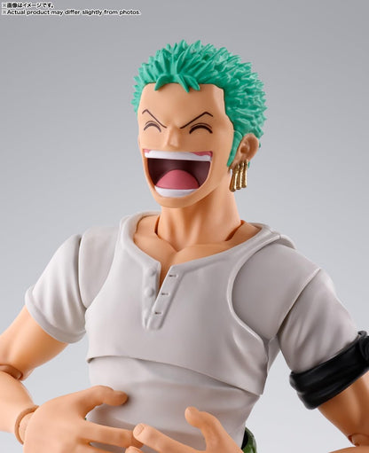 Action figure with green hair and a gray outfit on a gray background One Piece: Roronoa Zoro (Romance Dawn Ver.) Authentic S.H. Figuarts Fully Articulated Action Figure by Bandai Spirits