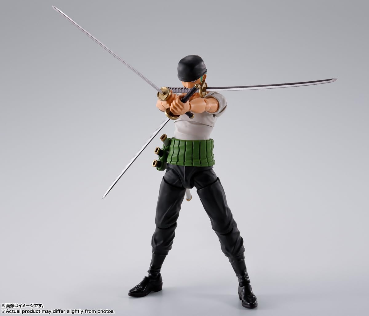 Action figure in a dynamic pose with a sword on a gray background One Piece: Roronoa Zoro (Romance Dawn Ver.) Authentic S.H. Figuarts Fully Articulated Action Figure by Bandai Spirits
