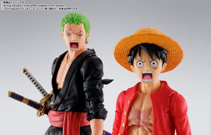 Two action figures of characters from a popular anime series on a gray background One Piece: Roronoa Zoro (The Raid on Onigashima Ver.) Authentic S.H. Figuarts Fully Articulated Action Figure by Bandai Spirits