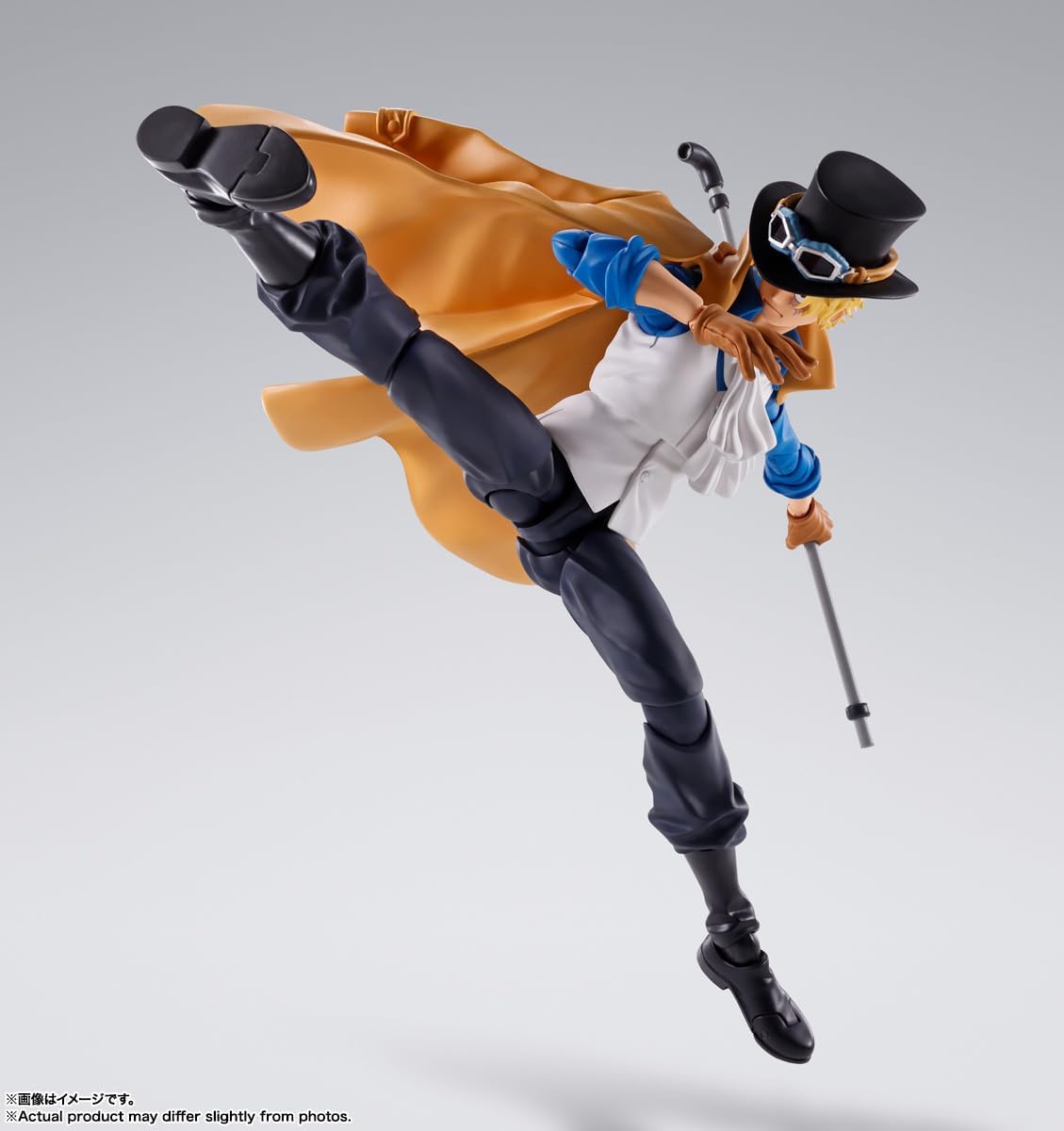 Action figure in dynamic pose with orange cape and top hat on a gray background One Piece: Sabo (Revolutionary Army Chief of Staff Ver.) Authentic S.H. Figuarts Fully Articulated Action Figure by Bandai Spirits
