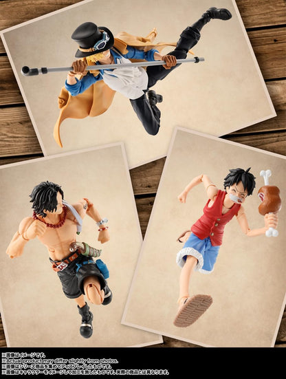 Three action figures on display with a wooden background One Piece: Sabo (Revolutionary Army Chief of Staff Ver.) Authentic S.H. Figuarts Fully Articulated Action Figure by Bandai Spirits