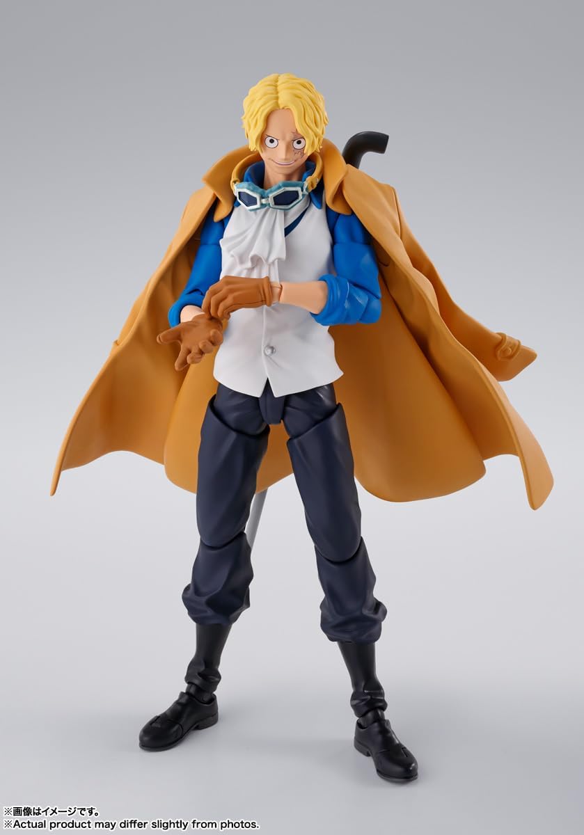 Action figure with a yellow coat and goggles on a gray background One Piece: Sabo (Revolutionary Army Chief of Staff Ver.) Authentic S.H. Figuarts Fully Articulated Action Figure by Bandai Spirits