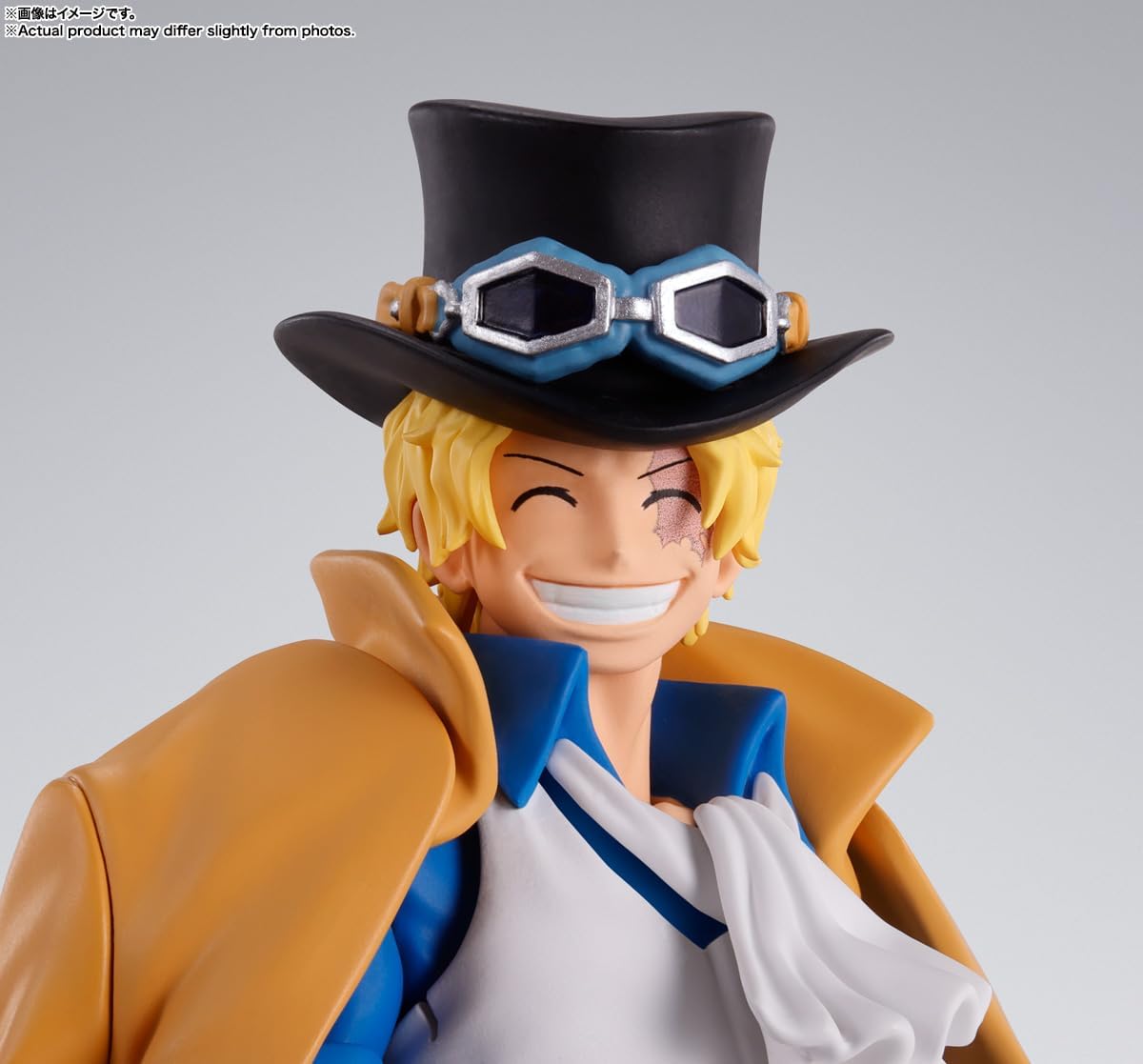 Figurine of a character with a top hat and goggles on a gray background One Piece: Sabo (Revolutionary Army Chief of Staff Ver.) Authentic S.H. Figuarts Fully Articulated Action Figure by Bandai Spirits