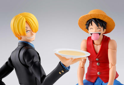 Two anime character figurines interacting with a plate of food on a gray background One Piece: Sanji (Romance Dawn Ver.) Authentic S.H. Figuarts Fully Articulated Action Figure by Bandai Spirits