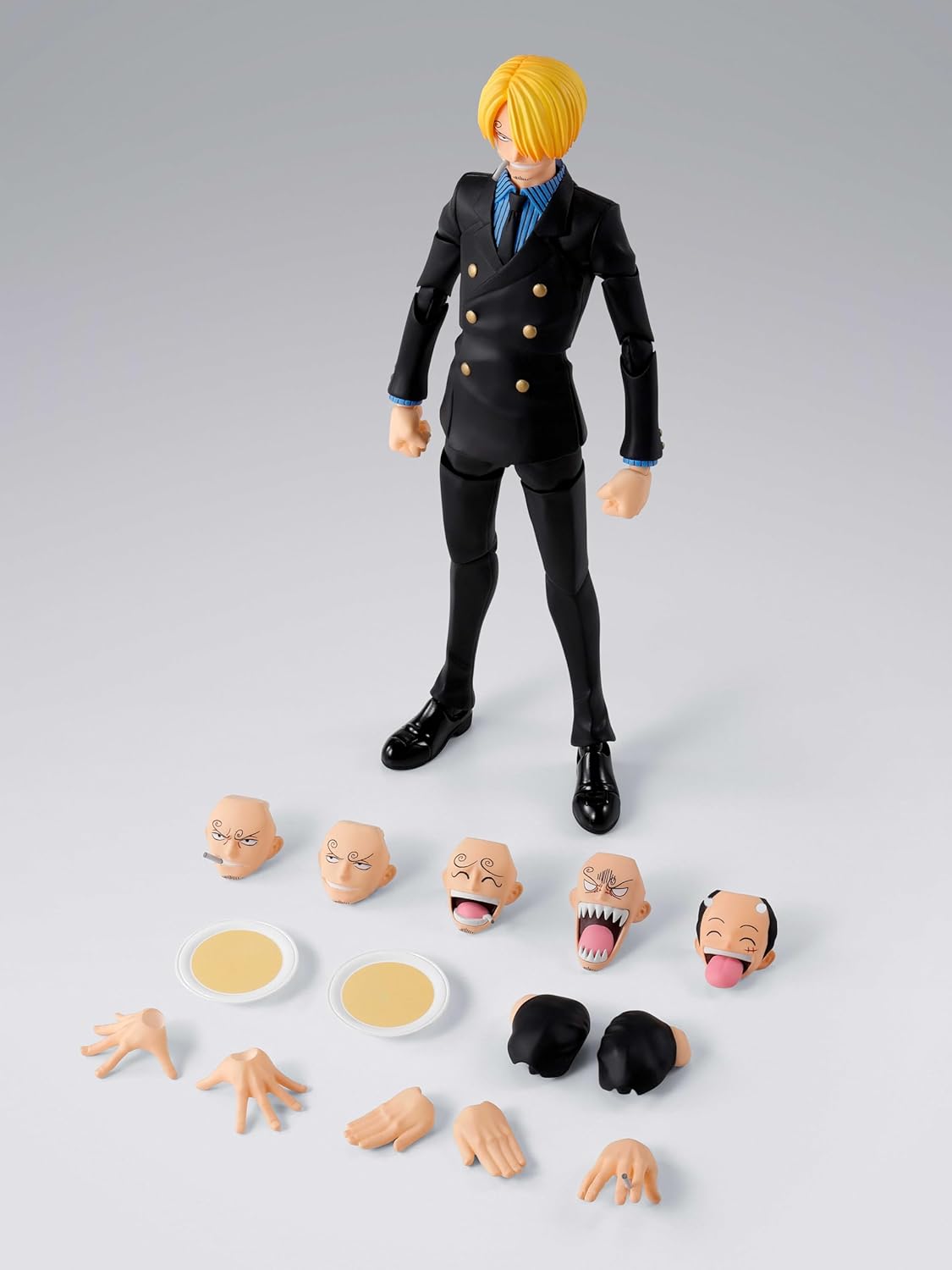 Action figure with interchangeable face parts on a gray background One Piece: Sanji (Romance Dawn Ver.) Authentic S.H. Figuarts Fully Articulated Action Figure by Bandai Spirits