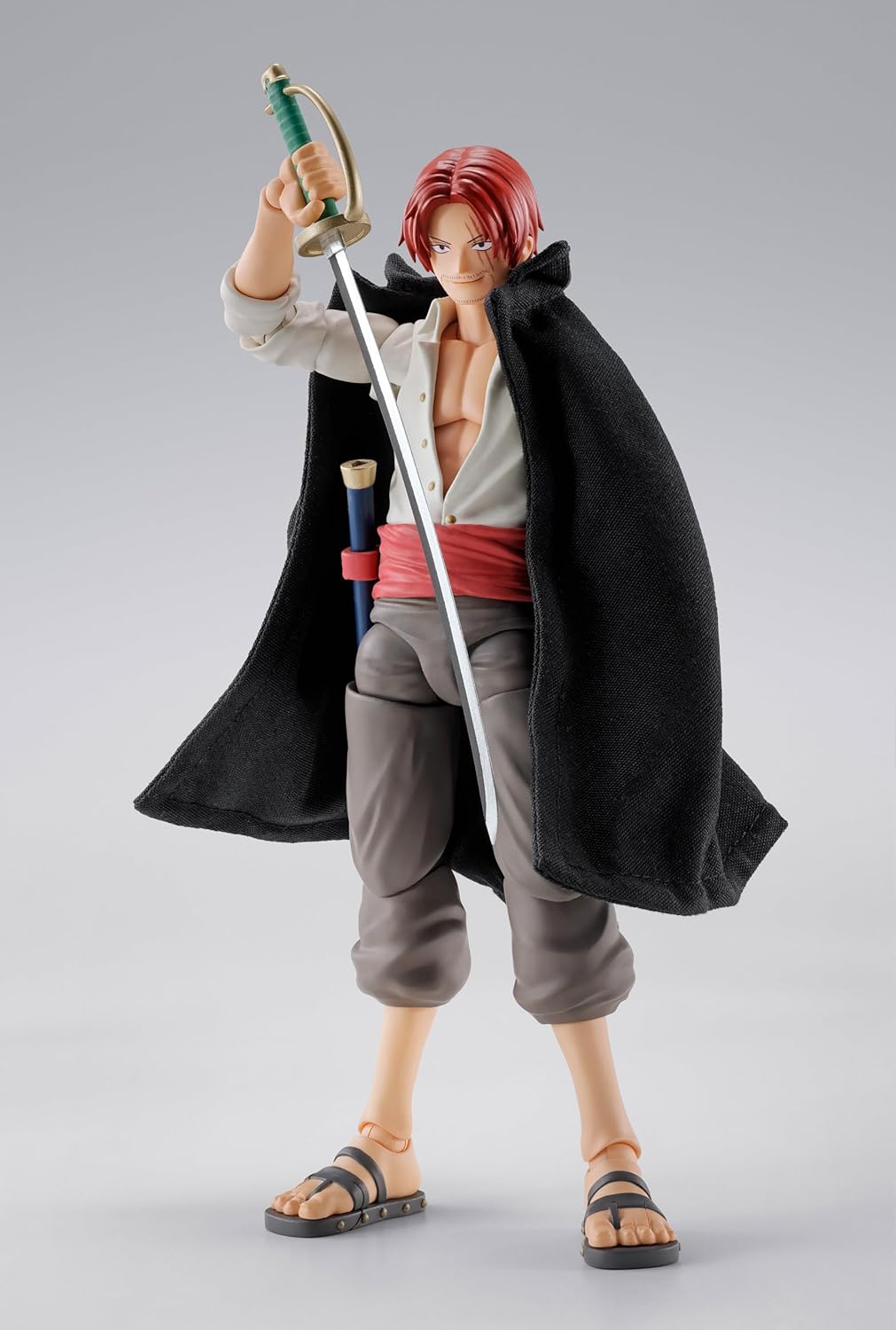 Action figure of a character with red hair and a sword on a gray background One Piece: Shanks & Monkey D. Luffy (Childhood Ver.) Authentic S.H. Figuarts Fully Articulated Twin-Pack Action Figure Set by Bandai Spirits