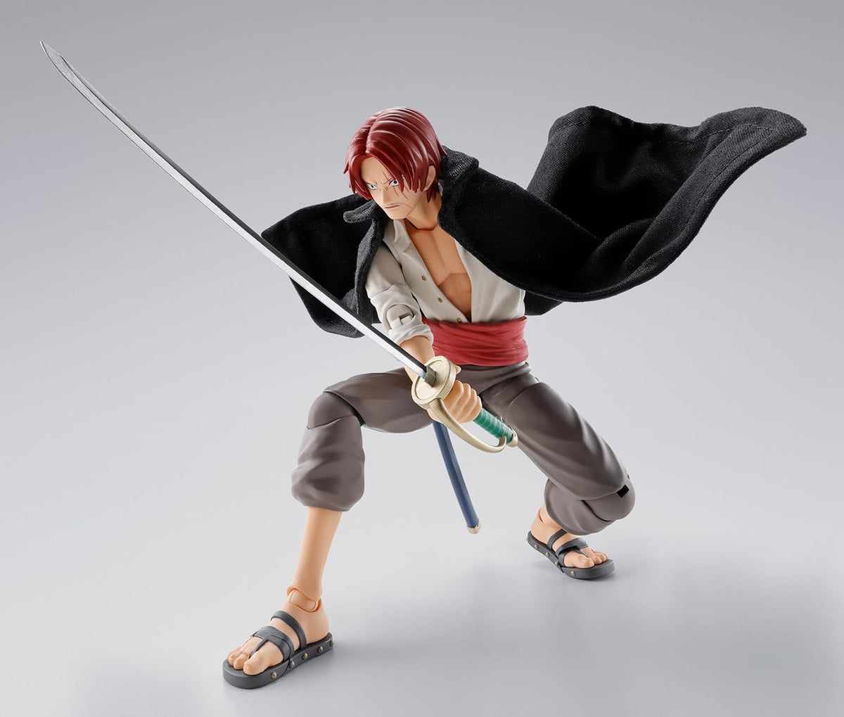 Action figure with red hair and a sword on a gray background One Piece: Shanks & Monkey D. Luffy (Childhood Ver.) Authentic S.H. Figuarts Fully Articulated Twin-Pack Action Figure Set by Bandai Spirits