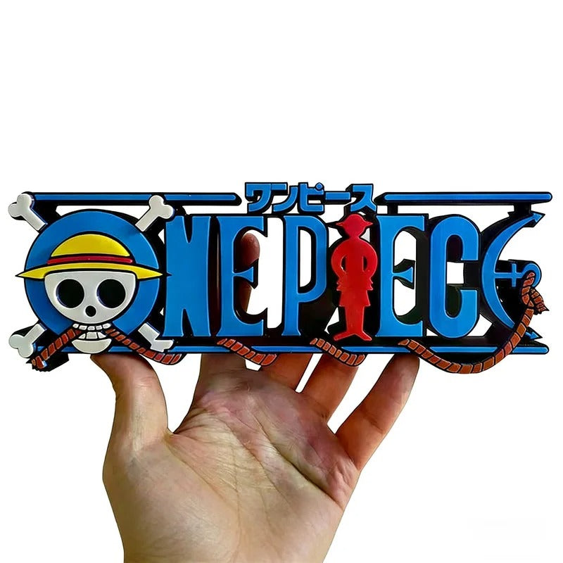 One Piece logo held in a hand against a white background One Piece: Straw Hat Pirates Jolly Roger 3D Printed Standing Logo Sign – Premium 15cm Desktop Display & Media Shelf Anchor