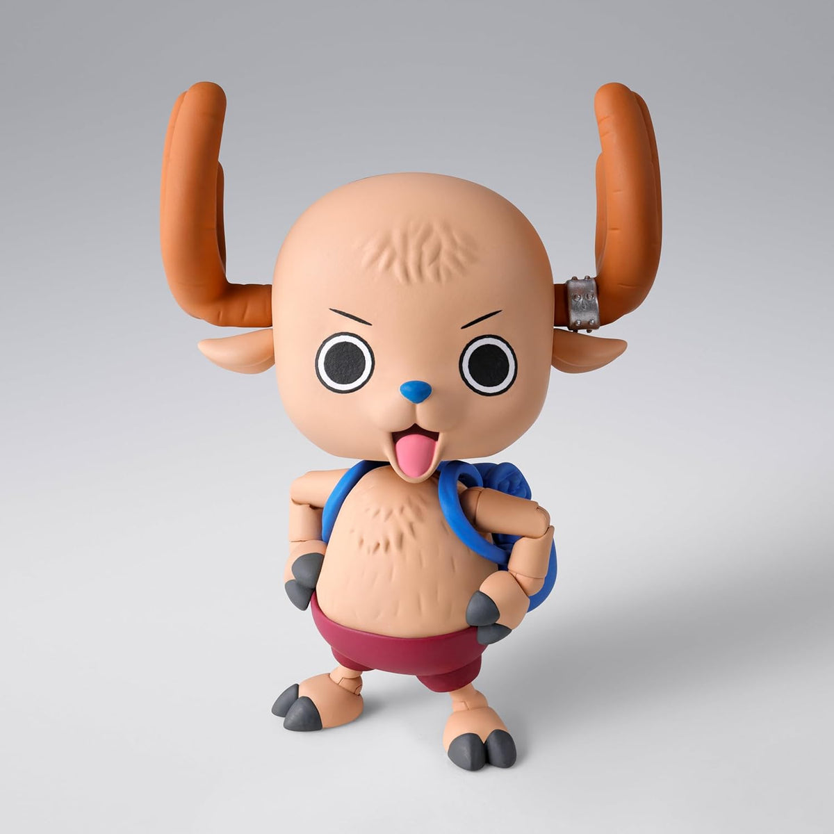 Toy figure with large horns and a blue strap on a gray background One Piece: Tony Tony Chopper (Drum Island Ver.) Authentic S.H. Figuarts Fully Articulated Action Figure by Bandai Spirits