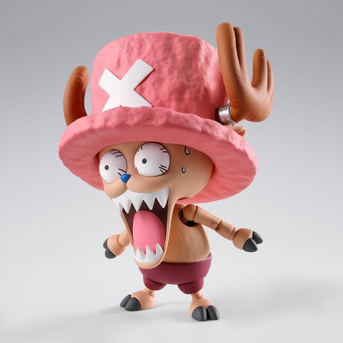 Toy figure with a pink hat and red shorts on a gray background One Piece: Tony Tony Chopper (Drum Island Ver.) Authentic S.H. Figuarts Fully Articulated Action Figure by Bandai Spirits