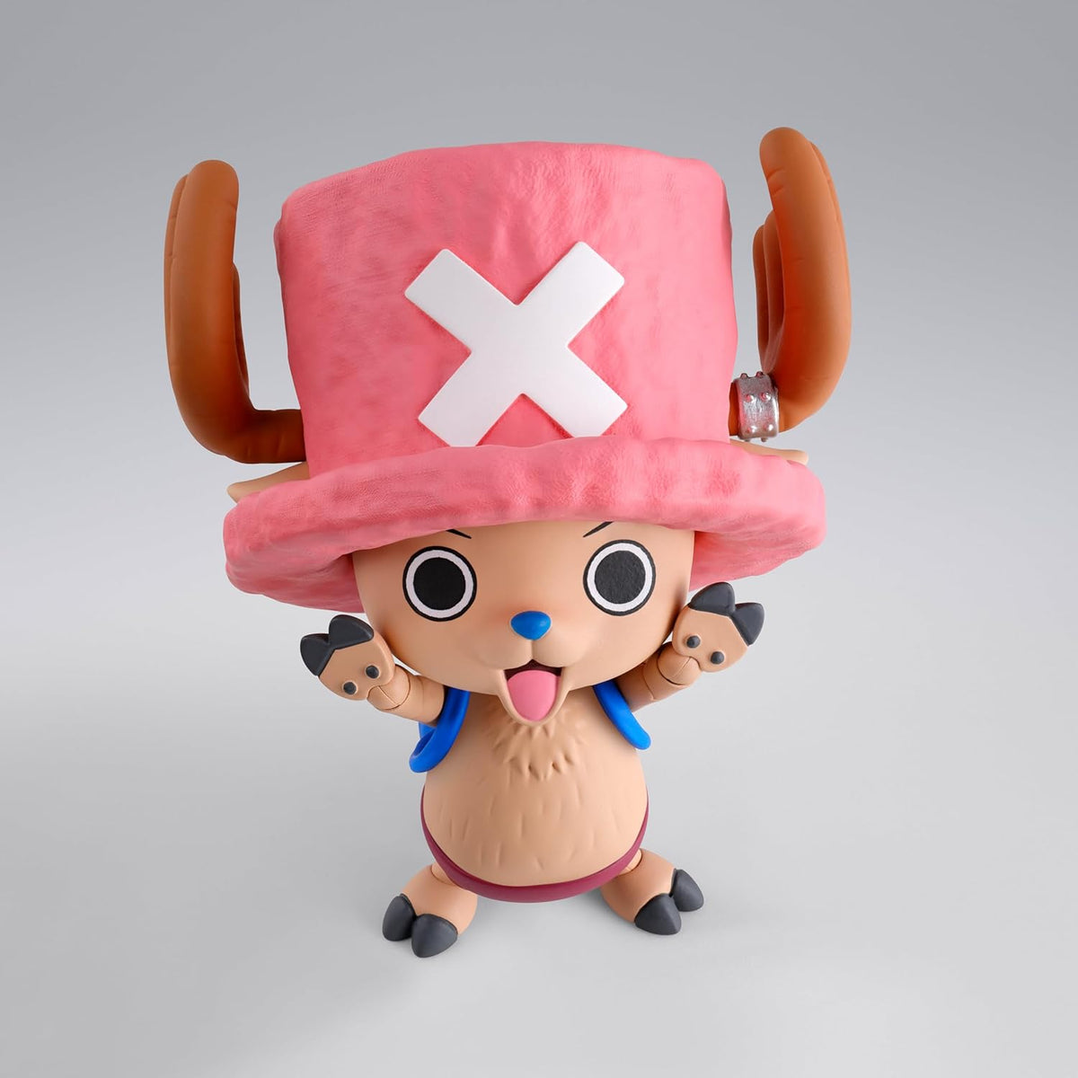 Toy figure with a pink hat featuring a white 'X' on a gray background One Piece: Tony Tony Chopper (Drum Island Ver.) Authentic S.H. Figuarts Fully Articulated Action Figure by Bandai Spirits