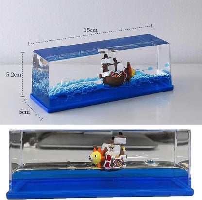 Model ship in a clear display case with blue base and measurements. One Piece: Unsinkable Ship Liquid Drift Bottle – Thousand Sunny & Going Merry Premium Acrylic Desktop Motion Decor with Separate USB LED Illuminating Base