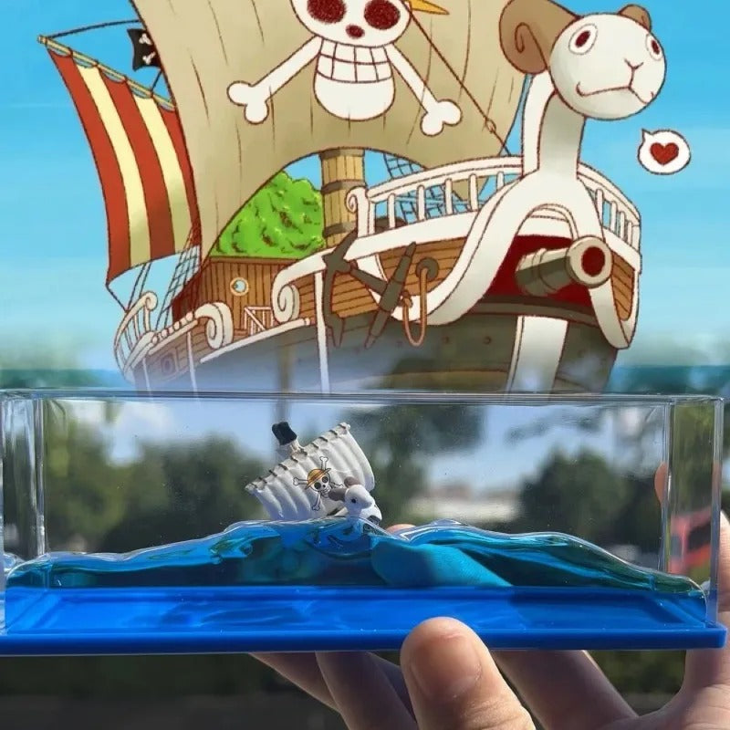 Toy ship with a monkey character on a clear stand against a scenic background One Piece: Unsinkable Ship Liquid Drift Bottle – Thousand Sunny & Going Merry Premium Acrylic Desktop Motion Decor with Separate USB LED Illuminating Base