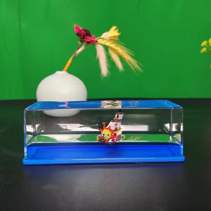 White ball with colorful feathers on a clear stand against a green screen One Piece: Unsinkable Ship Liquid Drift Bottle – Thousand Sunny & Going Merry Premium Acrylic Desktop Motion Decor with Separate USB LED Illuminating Base
