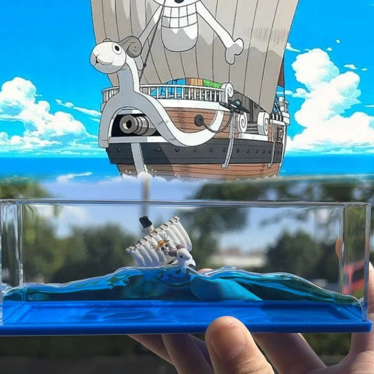 Model ship on a transparent stand with a scenic background One Piece: Unsinkable Ship Liquid Drift Bottle – Thousand Sunny & Going Merry Premium Acrylic Desktop Motion Decor with Separate USB LED Illuminating Base