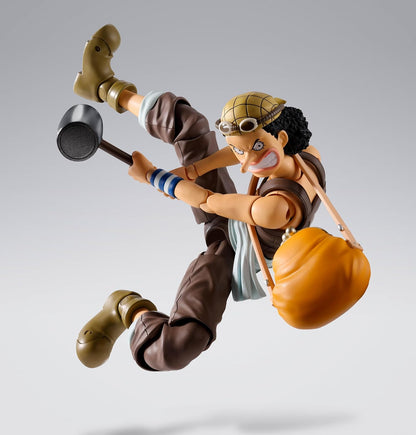 Action figure of a character from an animated series on a gray background One Piece: Usopp (Romance Dawn Ver.) Authentic S.H. Figuarts Fully Articulated Action Figure by Bandai Spirits