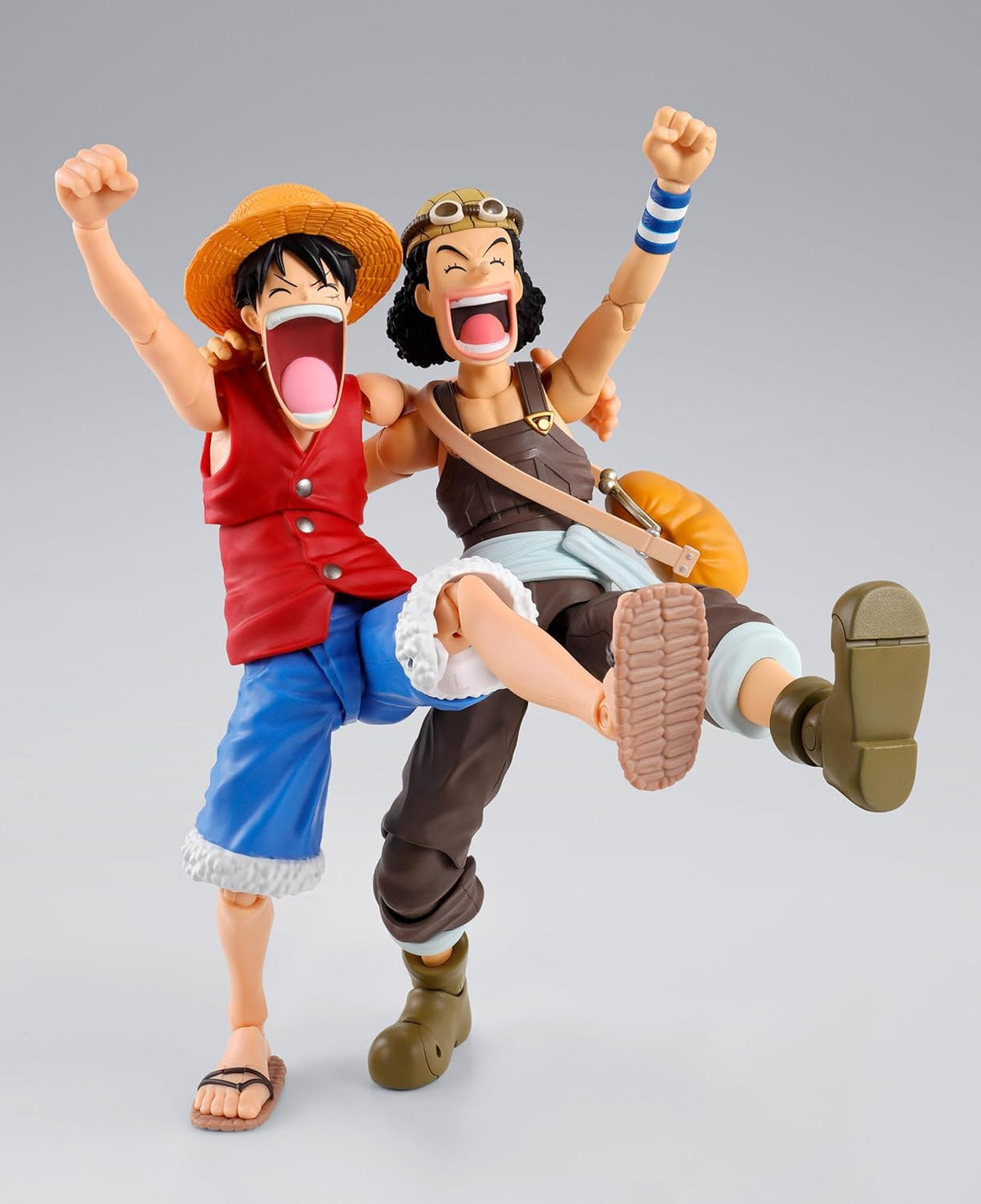 Two animated character action figures on a gray background One Piece: Usopp (Romance Dawn Ver.) Authentic S.H. Figuarts Fully Articulated Action Figure by Bandai Spirits
