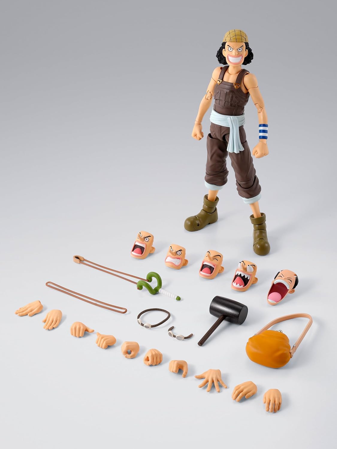Action figure with interchangeable parts on a gray background One Piece: Usopp (Romance Dawn Ver.) Authentic S.H. Figuarts Fully Articulated Action Figure by Bandai Spirits