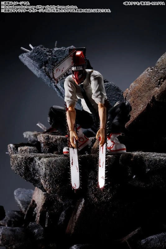 Action figure holding a knife on rocky terrain with a dark background S.H.Figuarts Chainsaw Man Authentic Action Figure – 5.9-Inch Fully Articulated Premium Collectible Character Statue by Bandai Tamashii Nations diorama