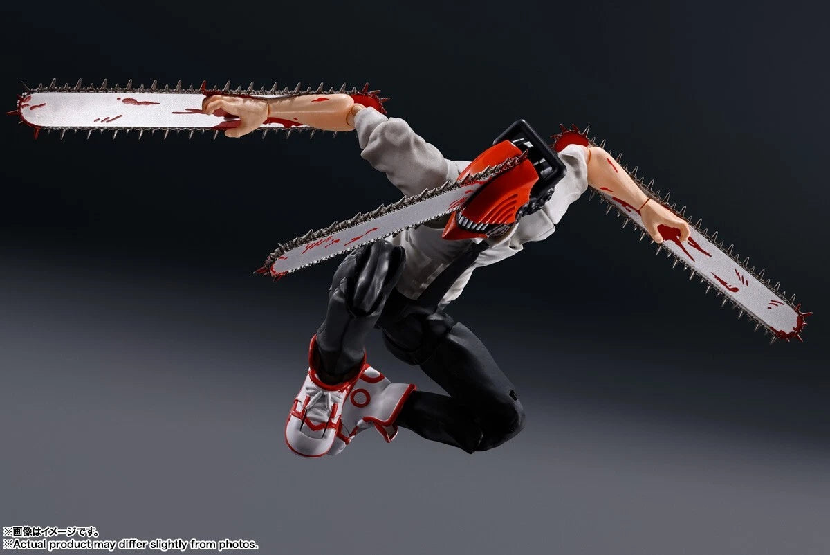 Action figure with a chainsaw weapon on a dark background. S.H.Figuarts Chainsaw Man Best Selection Authentic Action Figure – 15cm Fully Articulated Tamashii Nations Store Limited Exclusive Edition pose