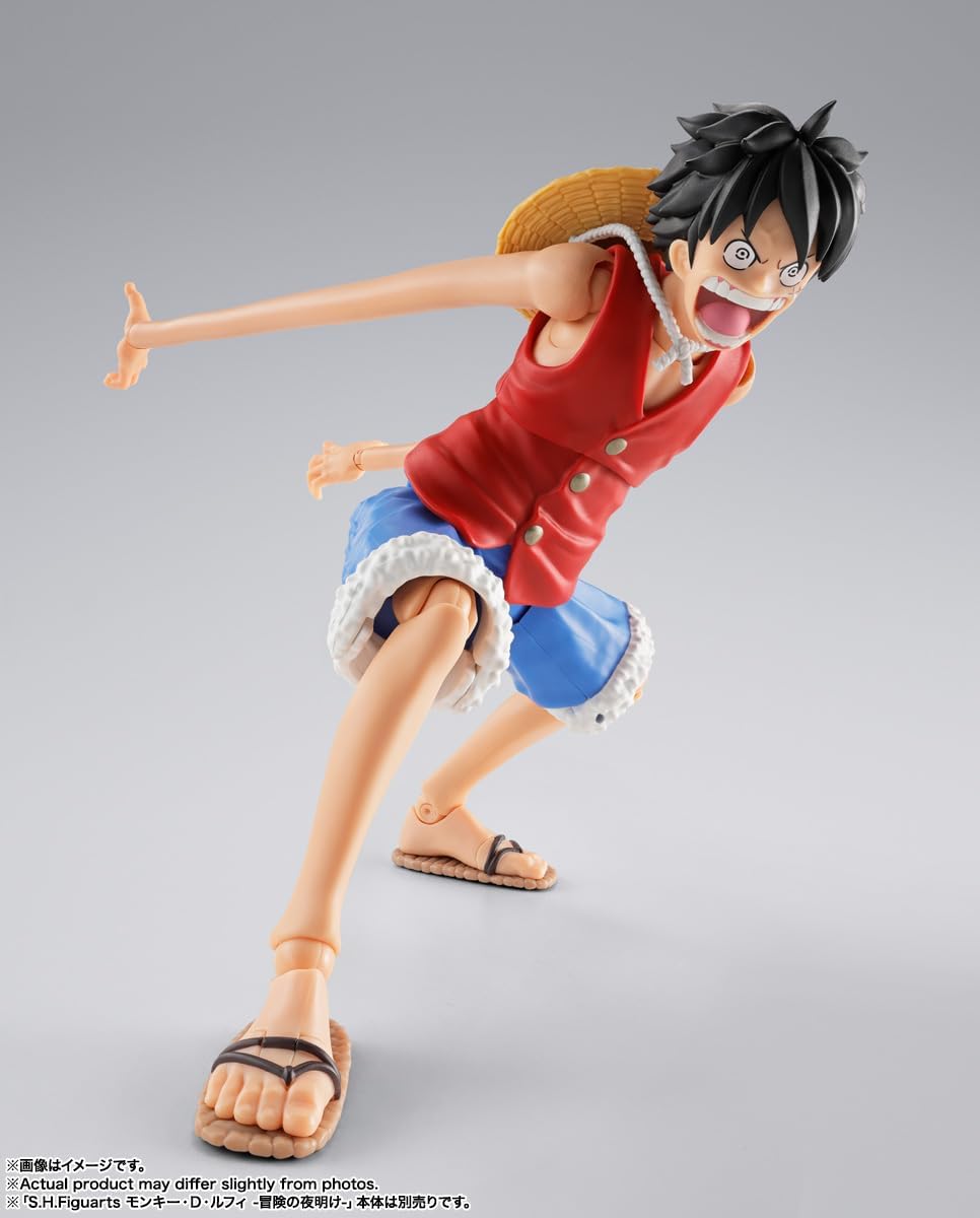 Action figure of a character in a red shirt and blue shorts on a gray background S.H. Figuarts One Piece: Monkey D. Luffy - Dawn of Adventures - Rubber Rubber Optional Parts Set by Bandai Spirits