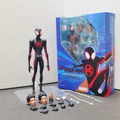 Spider-Man action figure with interchangeable heads and packaging on a gray floor. Spider-Man: Across The Spider-Verse 1/12 Scale Collectible Action Figures by CT Toys