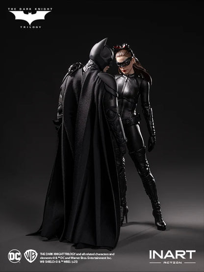Two superhero figures, one in a cape and the other in a suit, standing close together on a dark background with logos at the top and bottom.