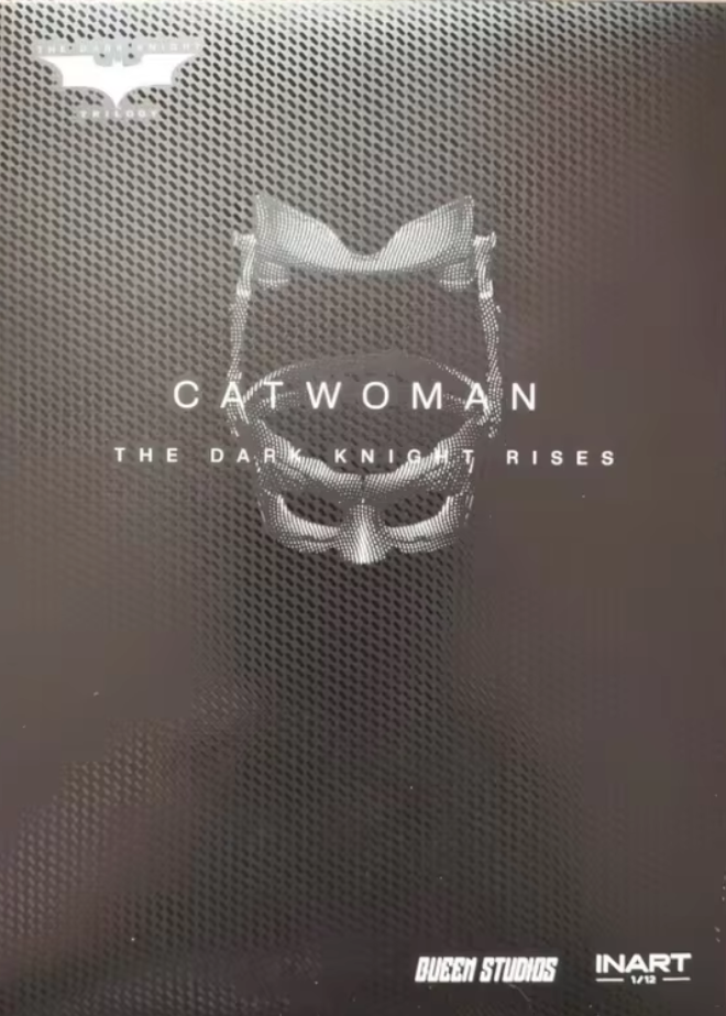 Promotional poster for 'Catwoman' from 'The Dark Knight Rises' with a mask design on a textured background. The Dark Knight Rises Catwoman 1/12 Scale Collectible Action Figure by INART