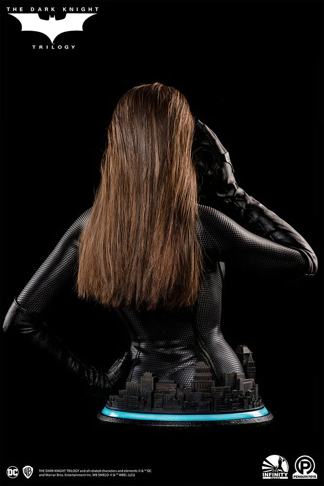 Statue of a character with long hair and a dark outfit on a black background, featuring 'The Dark Knight' Trilogy branding. The Dark Knight Rises Catwoman (Selina Kyle) 1:1 Scale Life-Size Masterpiece Bust by Infinity Studio x Penguin Toys