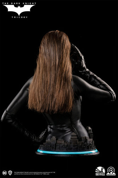 Statue of a character with long hair and a dark outfit on a black background, featuring 'The Dark Knight' Trilogy branding. The Dark Knight Rises Catwoman (Selina Kyle) 1:1 Scale Life-Size Masterpiece Bust by Infinity Studio x Penguin Toys