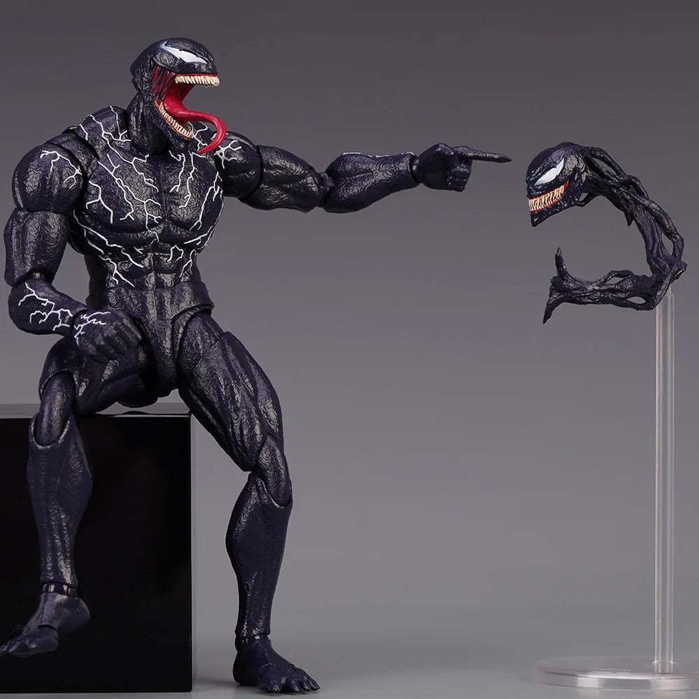 Action figure of a superhero in black suit with a red tongue, pointing to a small attached figure on a gray background. Venom: The Last Dance (Venom vs Spider-Man Edition) 1/12 Scale Action Figure