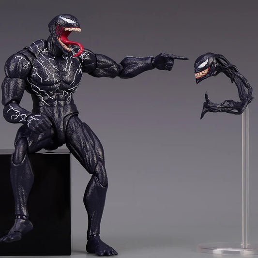 Action figure of a superhero in black suit with a red tongue, pointing to a small attached figure on a gray background. Venom: The Last Dance (Venom vs Spider-Man Edition) 1/12 Scale Action Figure