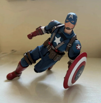 Action figure of a superhero in a blue suit with a red and white shield on a beige background War Hero "American Soul" (JM003) 1/12 Scale Collectible Action Figure by Joy Man Toys 