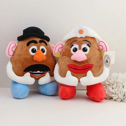 Two plush toy characters resembling a classic potato-headed couple, one with a black hat and mustache and one with a white flower hat, displayed side by side on a light surface against a white background. Official Toy Story Mr. & Mrs. Potato Head Premium Cotton Plush Collection by Titantoons