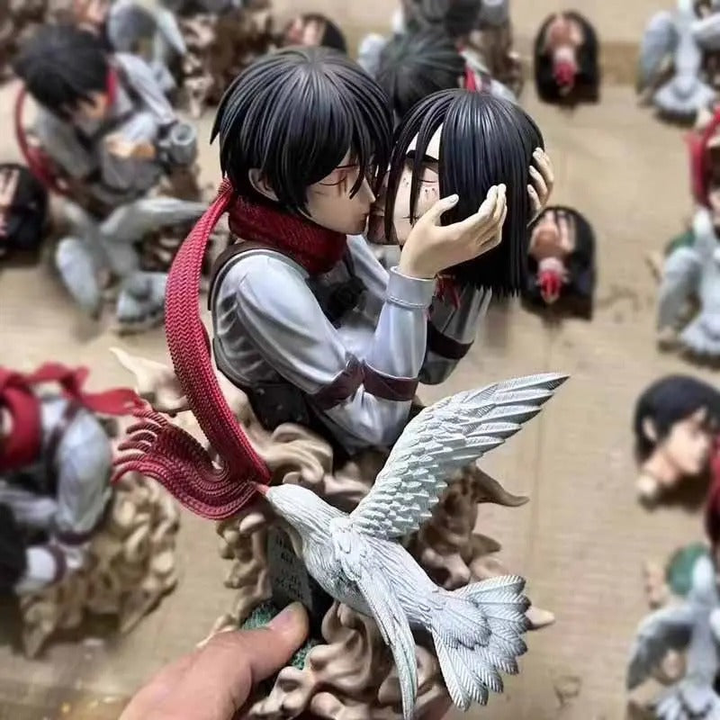 Two anime-style figurines embracing with a bird-like creature, surrounded by other figurines. Attack on Titan: Mikasa Ackerman & Eren Yeager "A Kiss of Death" Final Farewell Scene 1/8 Scale Limited Edition Resin Diorama Statue by LC Studio 