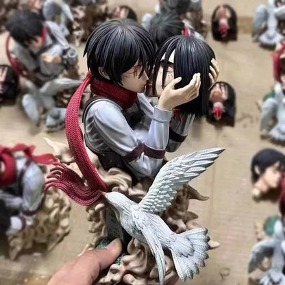 Two anime-style figurines embracing with a bird-like creature, surrounded by other figurines. Attack on Titan: Mikasa Ackerman & Eren Yeager "A Kiss of Death" Final Farewell Scene 1/8 Scale Limited Edition Resin Diorama Statue by LC Studio 